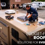 A Male Technician Repairing a Jayco Camper Roof Parked Outside of a Workshop