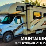 Thor Freedom Elite motorhome parked on a gravel lot at sunset