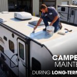 A Male Technician doing Roof Sealing of a Jayco Camper Roof parked outside of a workshop