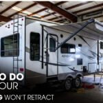 A 5th Wheel RV inside a Workshop for Awning Repair Works