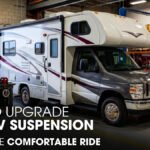 A Class C Motorhome Parked Inside a Workshop for Suspension Works