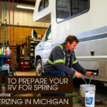 A Male Technician Preparing RV for spring inside a workshop