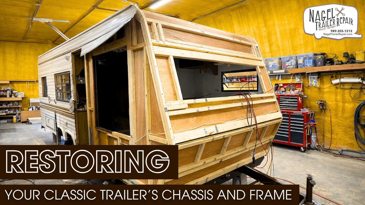 A camper trailer's wooden frame under renovation in a shop.
