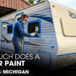 A Male Technician is Painting a Jayco Camper Exterior