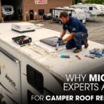 An RV Technician Repairing a Jayco Camper Roof Outside of a Workshop
