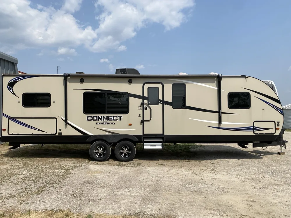 KZ Connect travel trailer in full clean side profile at the yard at Nagel Trailer Repair in Merrill, Michigan